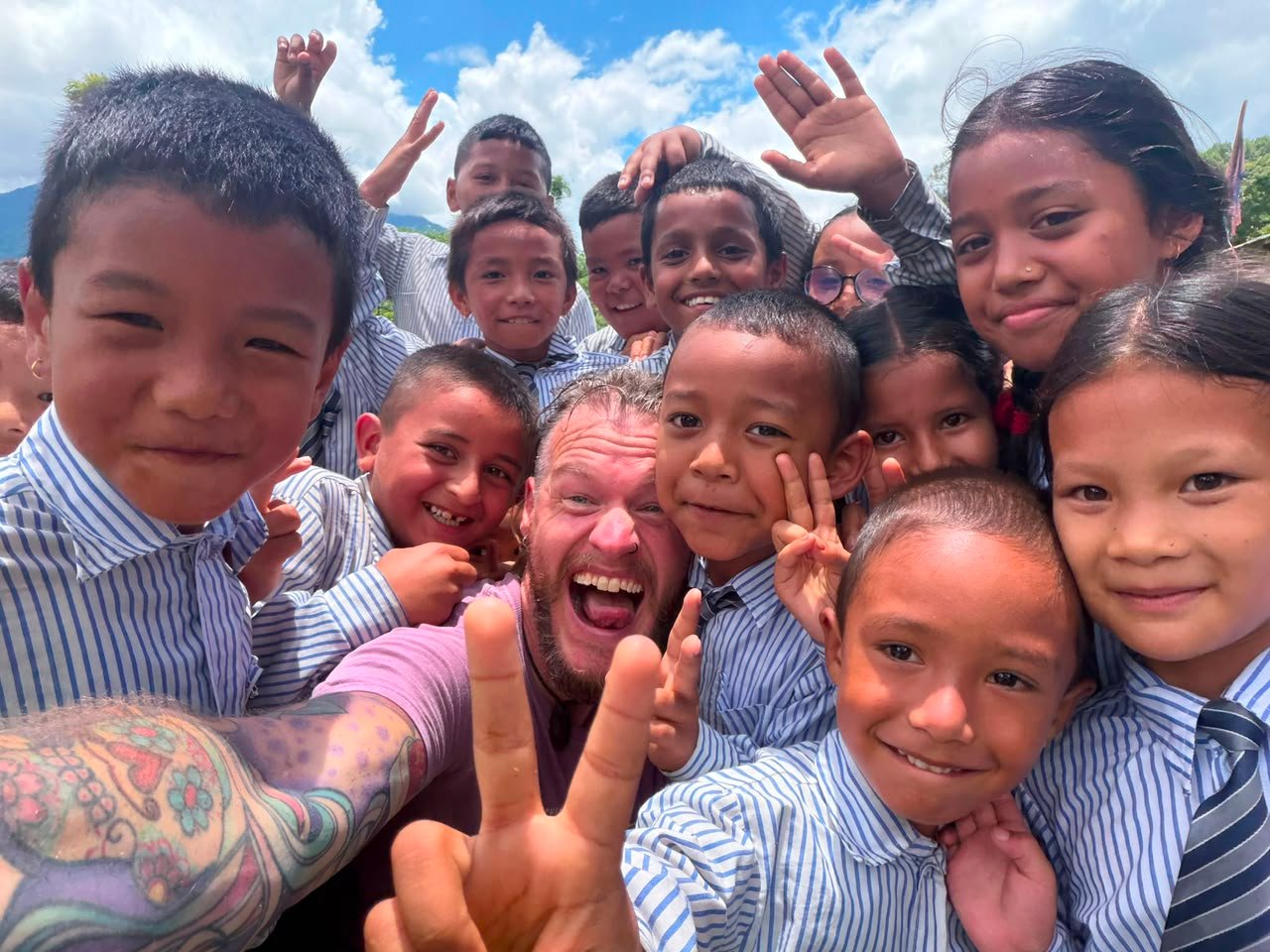 Nepalese school children smiling in rural school compounding